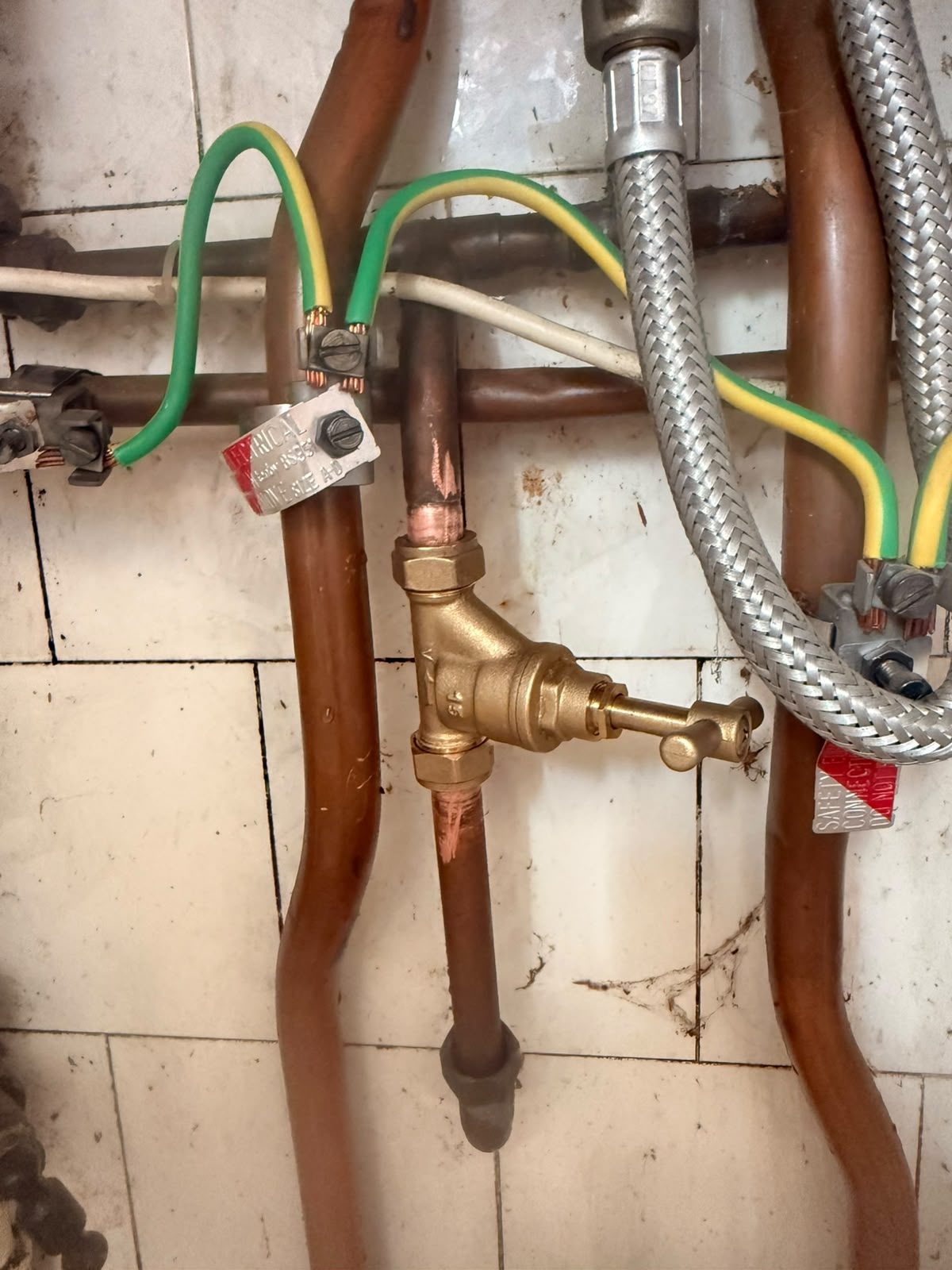 Central heating drain-off valve, copper pipework and earth bonding fitted during a heating system installation