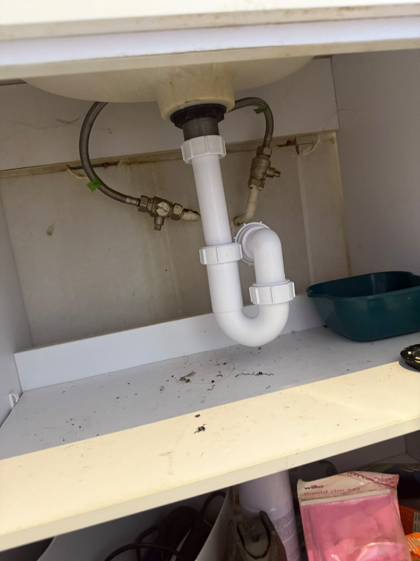 Replacement basin waste and P-trap fitted with isolation valves in an under-sink cupboard
