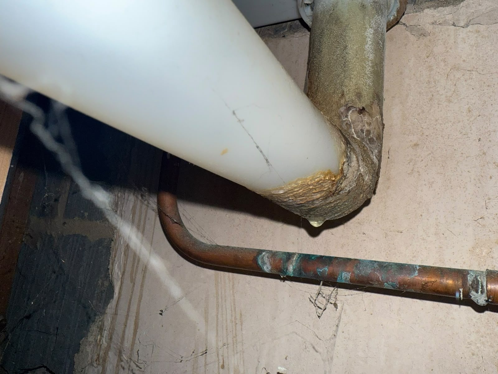 Corroded waste pipe joint dripping water, found and traced during a leak detection call-out