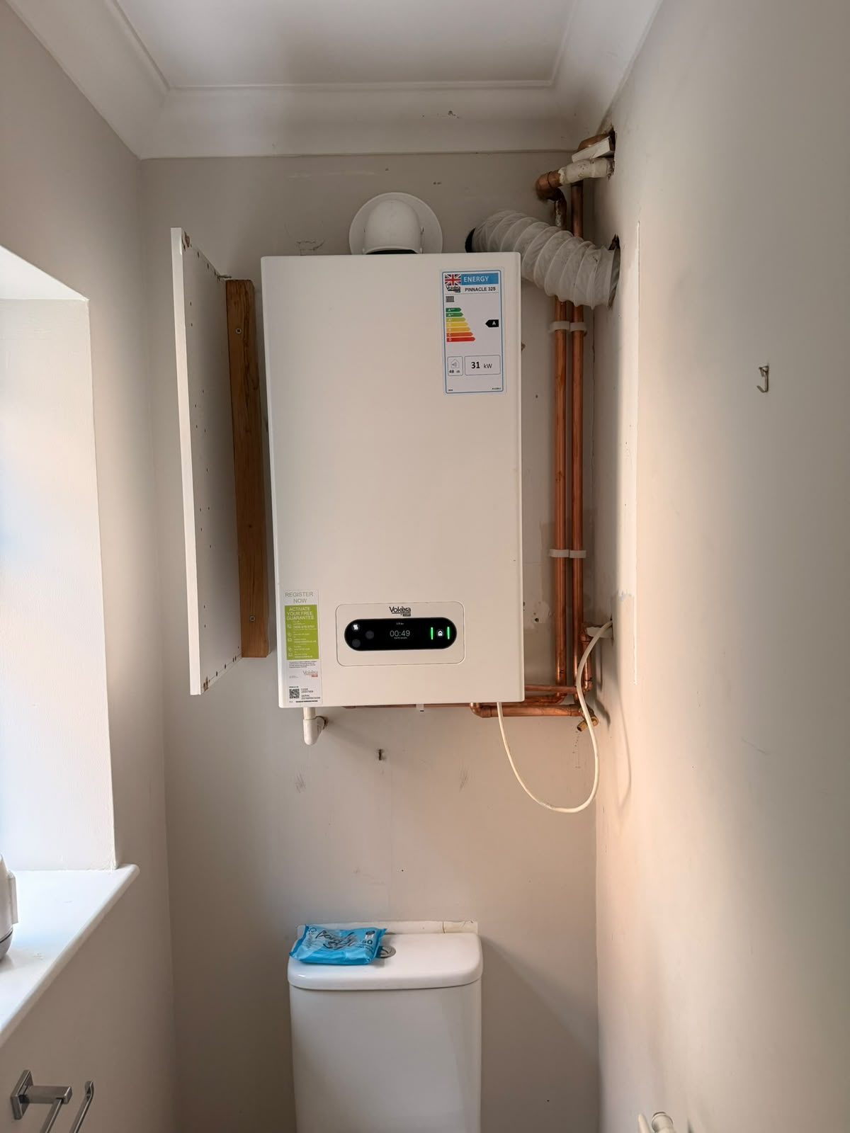 Vokera Pinnacle 32kW combi boiler installed in an airing cupboard with new copper flow and return pipework